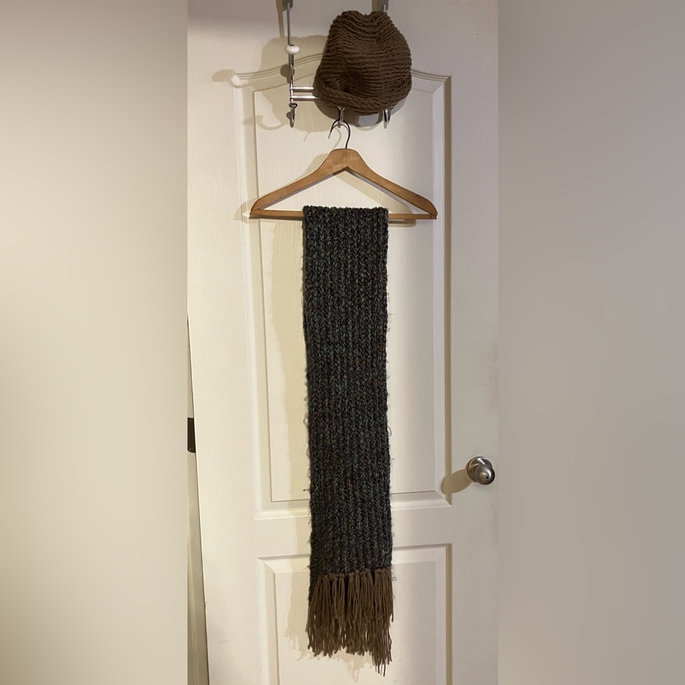 Handcrafted scarf and matching cap. Scarf has shades of brown with teal.